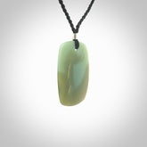 This is a Inanga Jade contemporary Drop pendant carved here in New Zealand by Josey Coyle. It is carved from a piece of rare New Zealand Inanga Pounamu, Jade. The jade is a subtle blue/green colour. A very finely carved pendant with an adjustable black cord.
